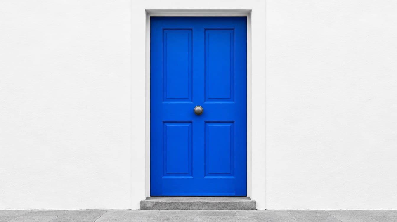 A bright blue front door in a white wall
